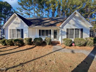 Charming, single-story home featuring a well-manicured lawn and traditional architectural details at 337 Caroline Dr, Wendell, NC 27591