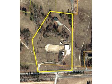 Aerial view showcasing the property's layout, including the house, stables, and outdoor riding arena at 7027 Old 421 Rd, Liberty, NC 27298