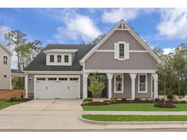Charming, craftsman-style home with a two-car garage, manicured lawn and beautifully landscaped yard at 9169 Dupree Meadow Dr # 26, Angier, NC 27501