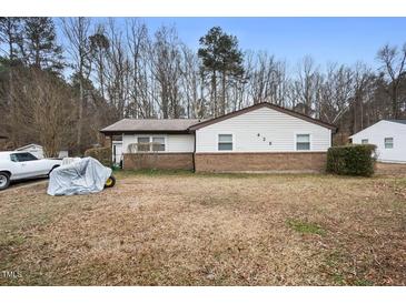 Modest single-story home with a brick foundation and a large front yard at 428 Walton St, Durham, NC 27703