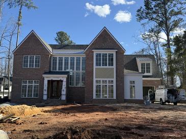 Stunning brick home with large windows, a modern aesthetic, and beautiful architectural details at 436 Oakland Dr, Raleigh, NC 27609
