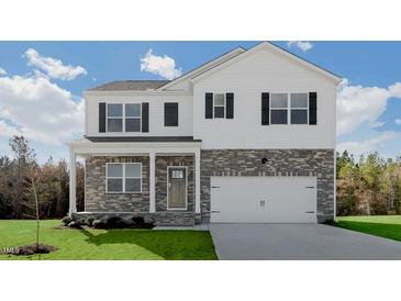 Charming two-story home featuring stone accents, white siding, black shutters and a well-manicured front lawn at 93 Fair Child Rd, Spring Lake, NC 28390