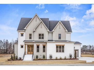 Stunning two-story home with white brick, accented by wooden trim and beautiful landscaping at 3812 Cobbler View Way, Fuquay Varina, NC 27526