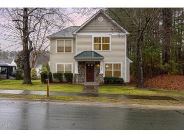 Charming two-story home featuring stone accents, a covered porch, and a well-maintained front lawn at 4102 Panther Creek Pkwy, Durham, NC 27704
