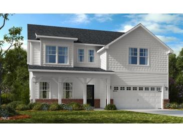 Charming two-story home with white siding, covered porch, and well-manicured lawn at 619 Contento Ct, Sanford, NC 27330