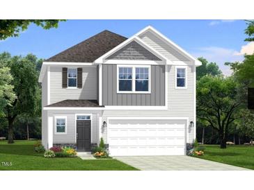Charming two-story home with gray and white siding, complemented by lush landscaping and a spacious two-car garage at 97 Willow Cameron Way, Angier, NC 27501