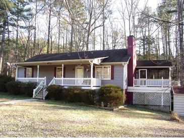 Charming single-story home with a spacious front porch and well-maintained landscaping at 105 Lake Rd, Henderson, NC 27537