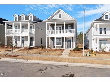 Charming two-story home featuring a welcoming front porch and neutral-colored siding at 264 White Oak Garden Way # 207, Garner, NC 27529