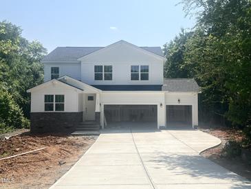 New two-story home with a large driveway and a two-car garage ready to be transformed into your dream home at 362 Barbour Farm Ln, Four Oaks, NC 27524