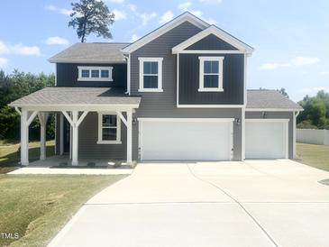 Beautiful two-story home with a two-car garage and a covered porch at 63 Lynn Crest Way, Four Oaks, NC 27524