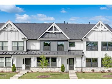 Charming townhomes with modern farmhouse appeal, featuring white siding and a well-manicured lawn at 913 Myers Point Dr, Morrisville, NC 27560