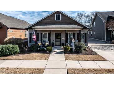 Charming home featuring a covered front porch, well-maintained landscaping, and an inviting entrance at 103 Bella Sq Sq, Smithfield, NC 27577