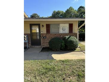 Inviting single-story home featuring brick accents, neat landscaping, and a welcoming front entrance at 130 S Estes Dr # J1, Chapel Hill, NC 27514