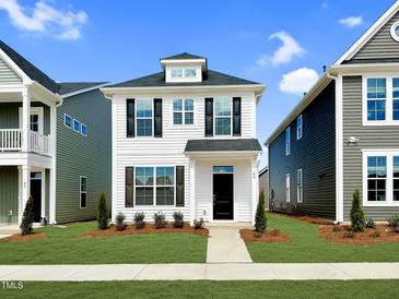 Charming two-story home featuring black shutters, a manicured lawn, and a welcoming black front door at 62 Blue Iris Pkwy # 125, Clayton, NC 27520