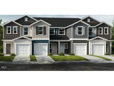 Charming townhome with multiple units, showcasing individual garages and a welcoming facade at 10523 Brookside Reserve Rd, Raleigh, NC 27614