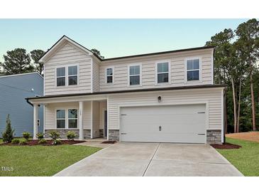 Charming two-story home with white siding, stone accents and a two car garage at 1229 Dimaggio Dr # 8, Raleigh, NC 27616