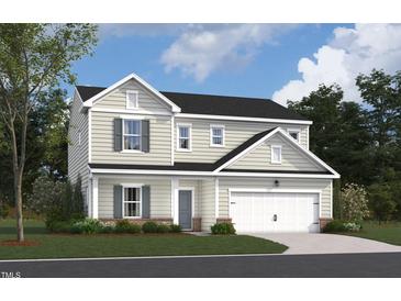 Charming two-story home featuring a blend of light siding, brick accents, and an attached two-car garage at 1241 Dimaggio Dr # 5, Raleigh, NC 27616