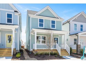 Charming two-story home features a covered front porch and a light blue exterior with white trim at 1250 Barreto Dr, Wendell, NC 27591