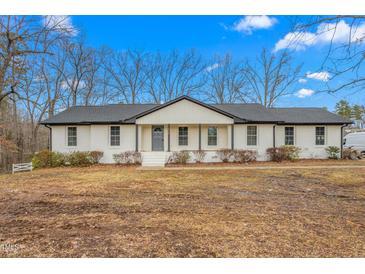 Charming renovated ranch-style home featuring a crisp white exterior and a newly installed roof at 206 Ellington Rd, Graham, NC 27253