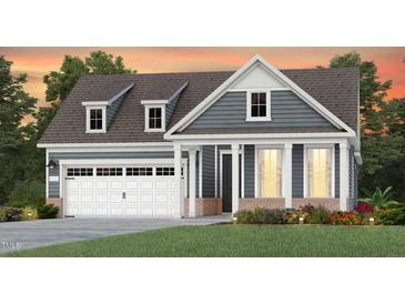 Charming two-story home with blue siding, white trim, dormer windows and an attached two-car garage at 294 Arcadius Dr, Clayton, NC 27520