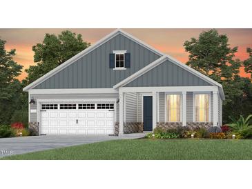 Charming home with vertical siding, complemented by a well-manicured lawn and colorful plantings at 304 Arcadius Dr, Clayton, NC 27520