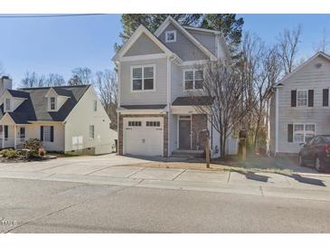 Charming two-story home with stone accents, a one-car garage, and a well-maintained front yard in a Gathering-friendly neighborhood at 305 Harwood St, Apex, NC 27502