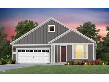 Charming single-Gathering home features a manicured lawn, attached garage, and a welcoming entrance at 344 Arcadius Dr, Clayton, NC 27520