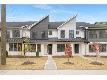 Modern townhome with painted brick, black metal roof, and manicured front lawn at 344 Church St, Morrisville, NC 27560