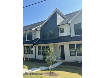 Modern townhome featuring a brick facade and a mix of dark and light siding and black window frames at 344 Church St, Morrisville, NC 27560