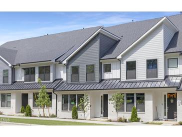 Beautiful townhouse with white brick and gray siding, complemented by well-maintained landscaping at 344 Church St, Morrisville, NC 27560