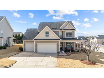 Charming two-story home boasts a two-car garage and beautifully landscaped front yard at 372 Lynshire Ave, Clayton, NC 27527