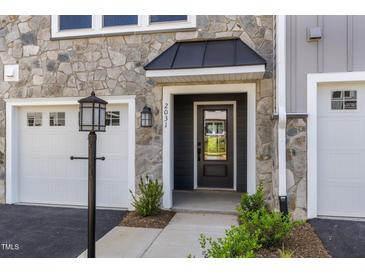 Inviting front entrance featuring a stone facade and a stylish black door with transom window at 509 Sherron Rd # 22, Durham, NC 27703