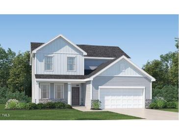 Charming two-story home featuring board and batten siding, complemented by a two-car garage and well-manicured landscaping at 536 Morning Light Dr, Angier, NC 27501