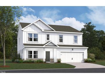 Charming two-story home boasts board and batten siding, a two-car garage, and a well-manicured lawn at 1233 Dimaggio Dr # 7, Raleigh, NC 27616