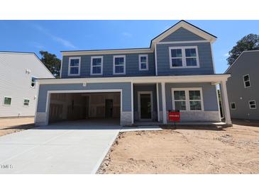 Beautiful two-story home with a large garage and light blue siding at 1240 Dimaggio Dr # 35, Raleigh, NC 27616