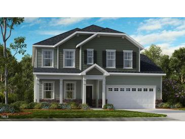 Inviting two-story home featuring a classic facade, attached garage, and nicely landscaped front yard at 253 Tidal Pool Way, Cary, NC 27519