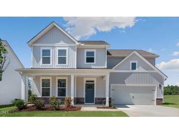 Charming two-story home with gray siding, covered porch, and manicured lawn at 326 Umstead St, Sanford, NC 27330