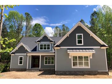 Charming home with gray siding, gabled roof, and stone accents, presenting a welcoming curb appeal at 1224 Red Cedar Ct # 33, Youngsville, NC 27596