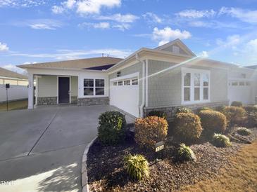 Charming single-story home featuring a welcoming entrance and attached two-car garage at 154 Magenta Rose Dr, Raleigh, NC 27610