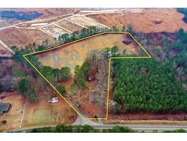 Expansive aerial view of property lines showcasing land, trees, and nearby road at 2502 Devils Racetrack Rd, Four Oaks, NC 27524
