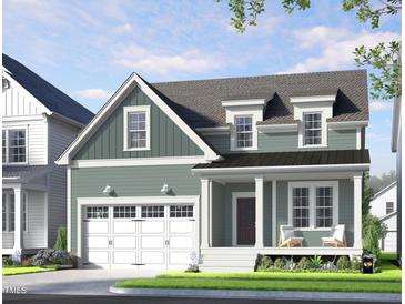Charming two-story home boasts a welcoming front porch and attached garage at 264 Big Bradley Dr, Wendell, NC 27591