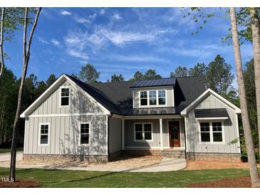 Charming craftsman-style home with gray siding, a stone foundation, and a well-manicured lawn at 3909 Cedar Knolls Dr # 6, Youngsville, NC 27596