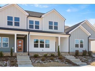 Charming new construction townhomes feature a welcoming entrance, and a meticulously landscaped front yard at 3920 Willow Gate Way, Raleigh, NC 27604