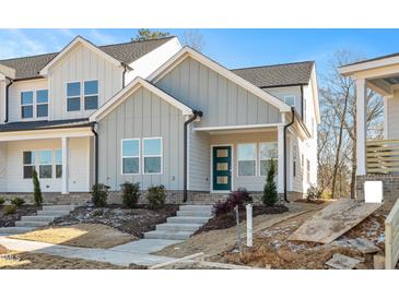 Charming townhome features gray siding, a blue front door, and well-manicured landscaping at 3928 Willow Gate Way, Raleigh, NC 27604