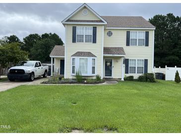 Charming two-story home with a well-manicured lawn and inviting curb appeal with attractive shutters at 711 Weathervane Way, Rocky Mount, NC 27803
