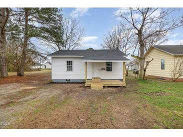 Charming single-story home with a fresh white exterior and inviting front porch at 1012 E Harnett St, Dunn, NC 28334