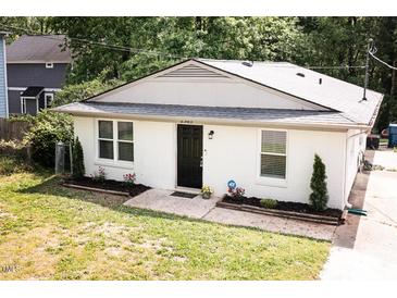 Charming single-story home featuring a newly painted exterior, manicured landscaping, and a welcoming entrance at 2305 Fitzgerald Ave, Durham, NC 27707