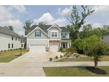 Beautiful two-story home featuring a two-car garage, manicured lawn, and tasteful landscaping at 2981 Thurman Dairy Loop, Wake Forest, NC 27587