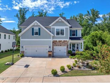 Charming two-story home boasts a large driveway, well-manicured landscaping, and an attached two-car garage at 2981 Thurman Dairy Loop, Wake Forest, NC 27587