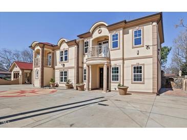 Stately two-story home featuring a symmetrical facade and decorative concrete driveway at 318 W Lillington St, Angier, NC 27501